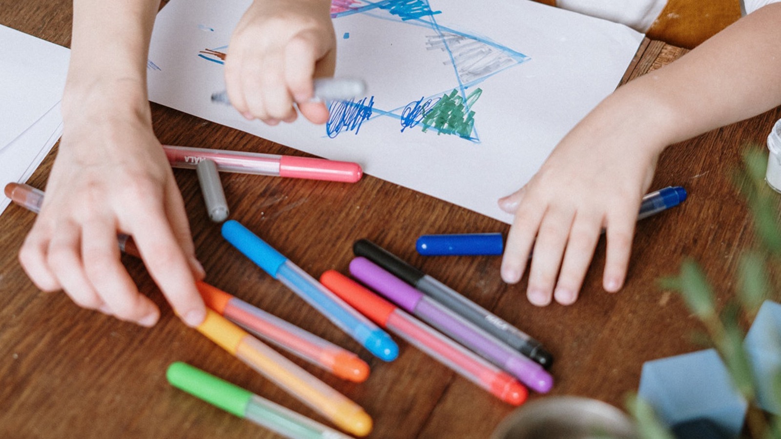 A child drawing with colorful markers
